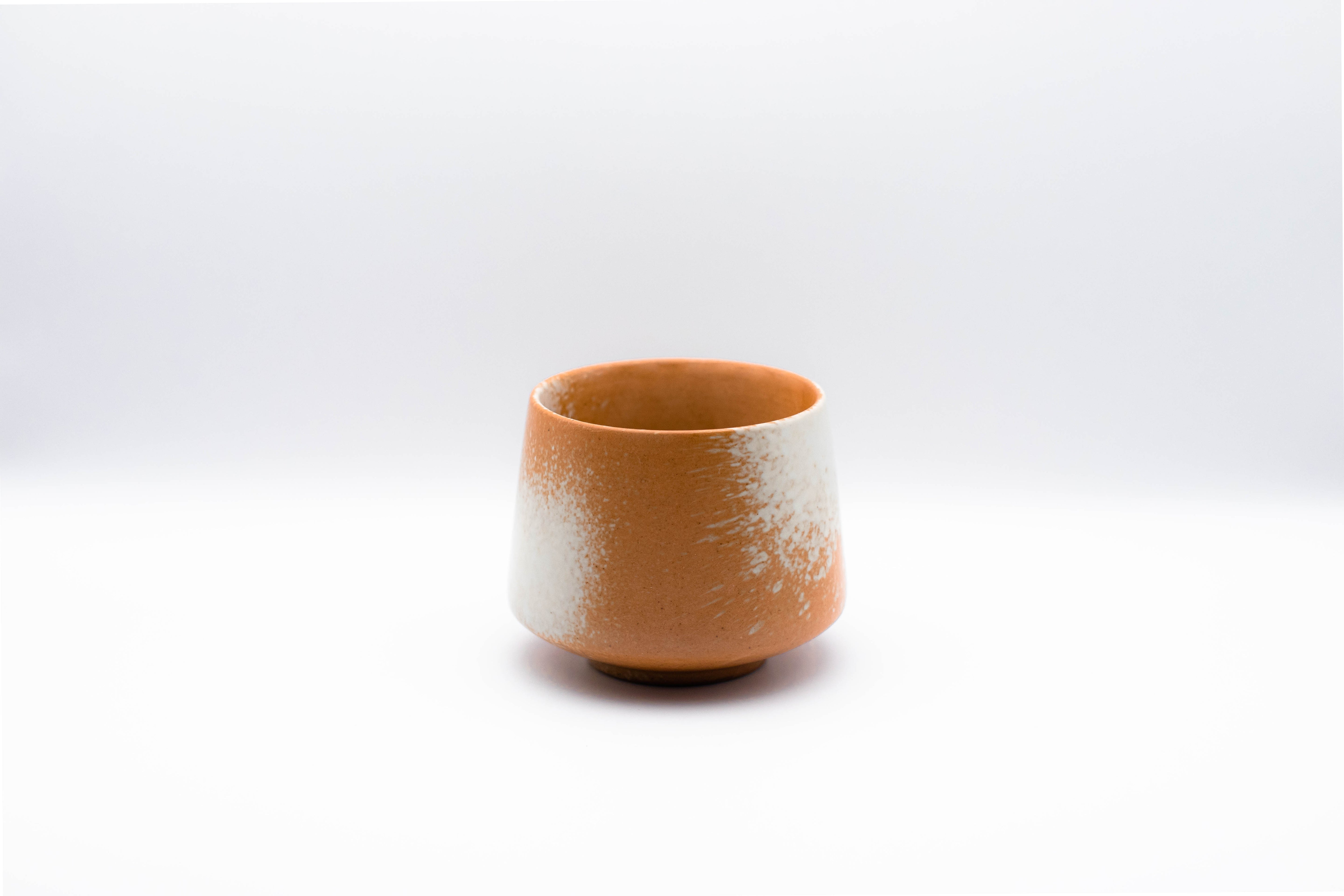 Stand-alone picture of our small Geisha ceramic cup in the color rusty orange.