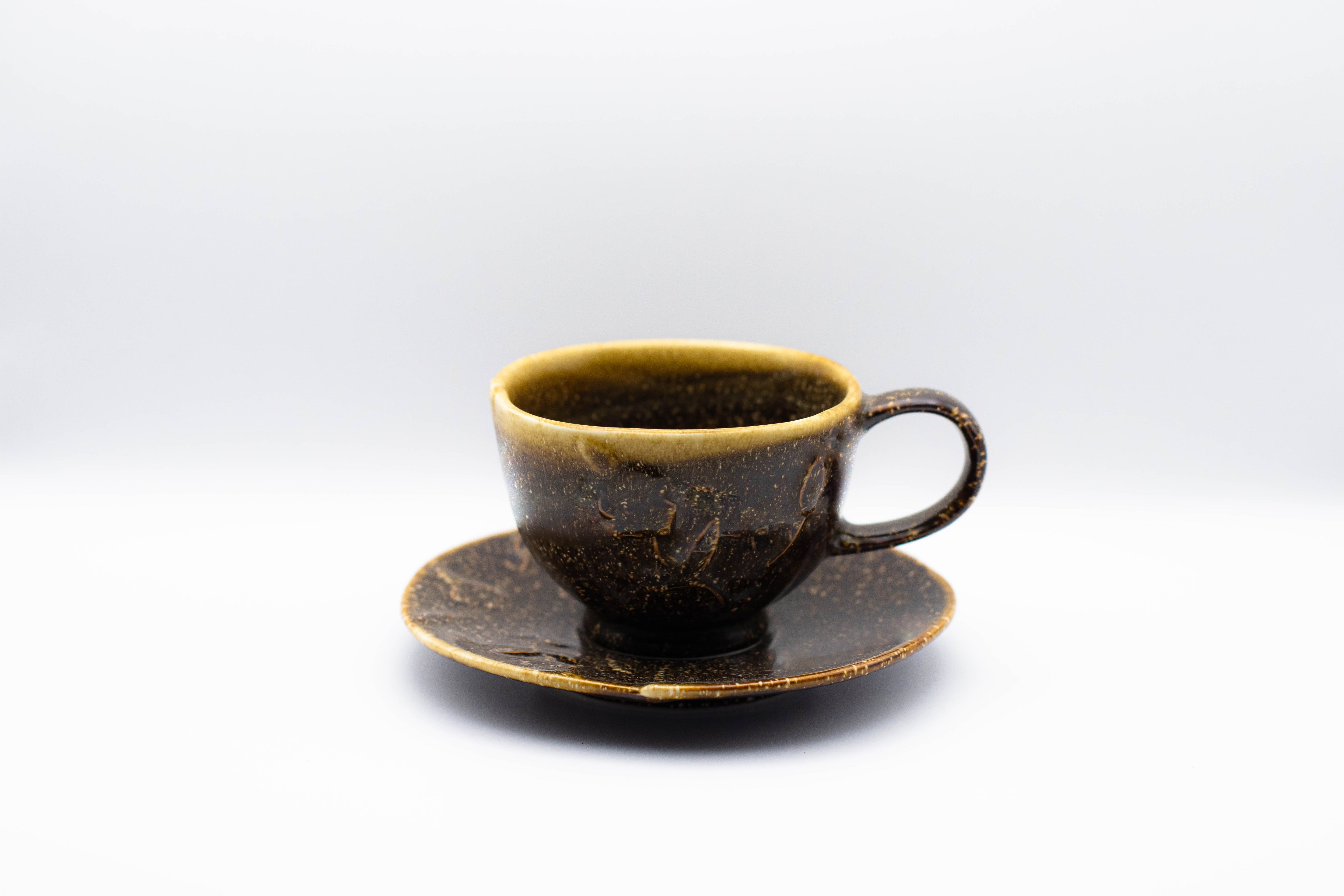 Stand-alone picture of our brown Hana Kasumi cup. A small cappuccino cup with flower relief, including saucer.