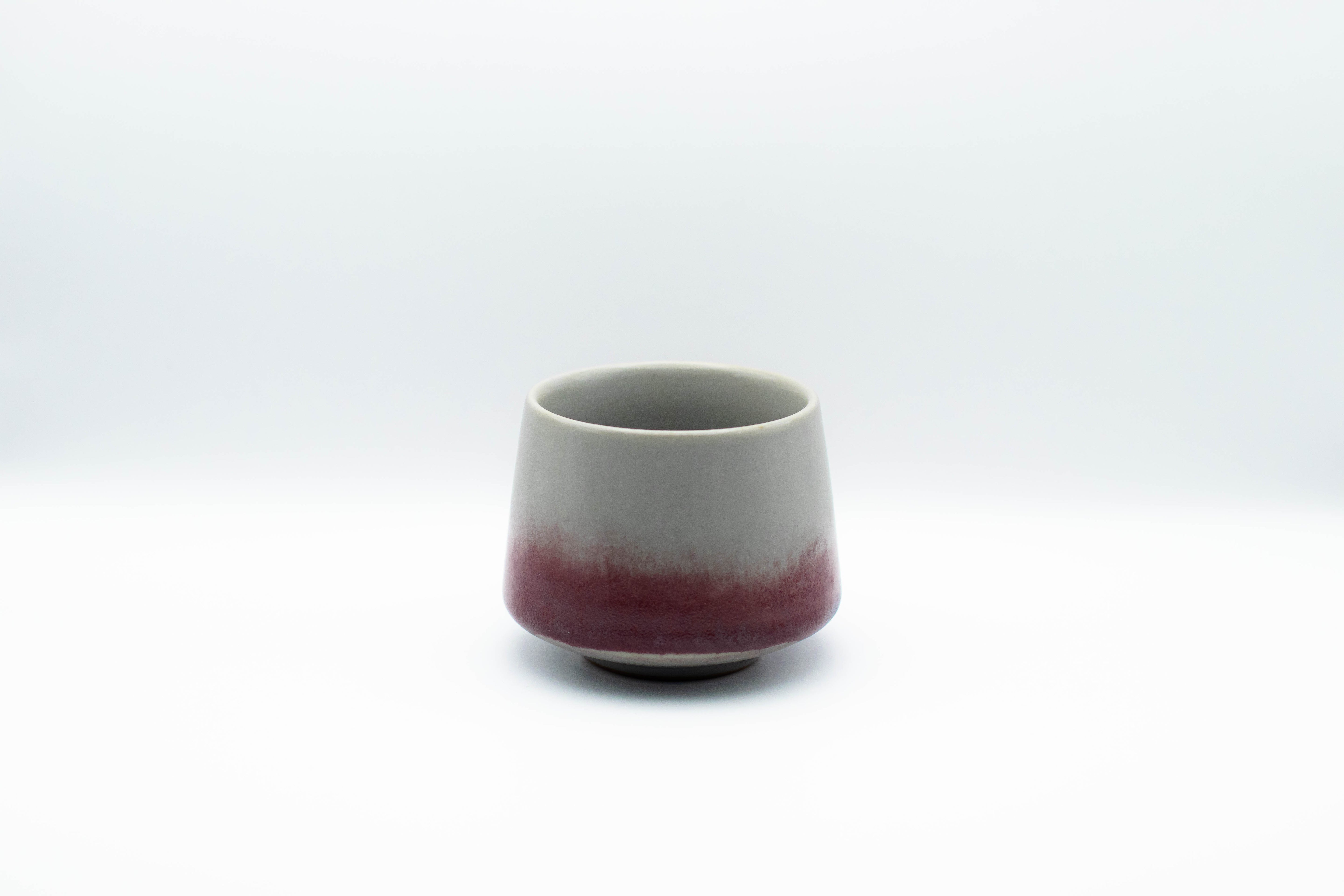 Stand-alone picture of our small ceramic Geisha cup in the color a grey color with purple gradient.