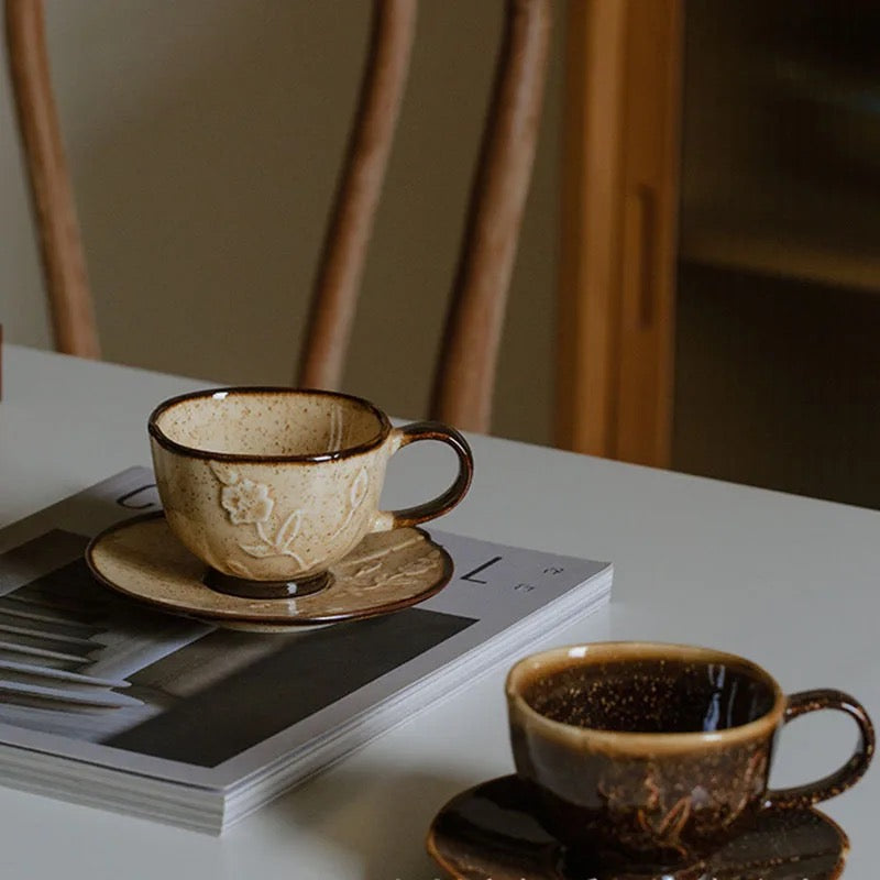 Our beige and brown Hana Kasumi ceramic cups in a table setting, placed on a magazine. 